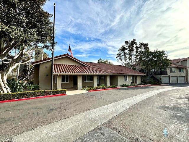 view of front of house featuring a tile roof and stucco siding