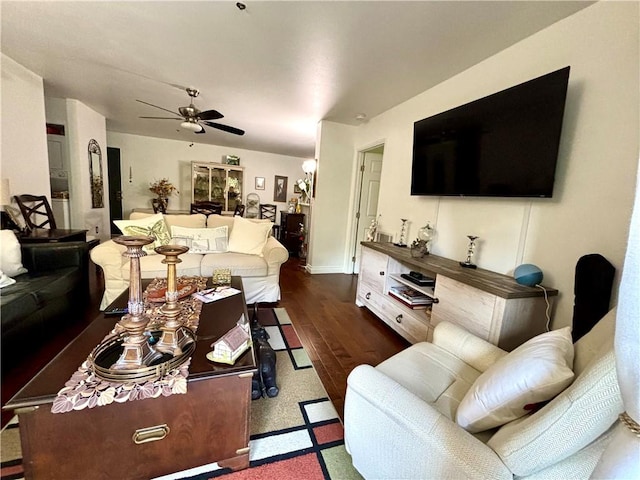 living room with ceiling fan and dark hardwood / wood-style flooring