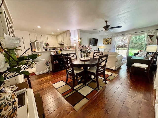 dining room featuring dark wood finished floors, a ceiling fan, and recessed lighting