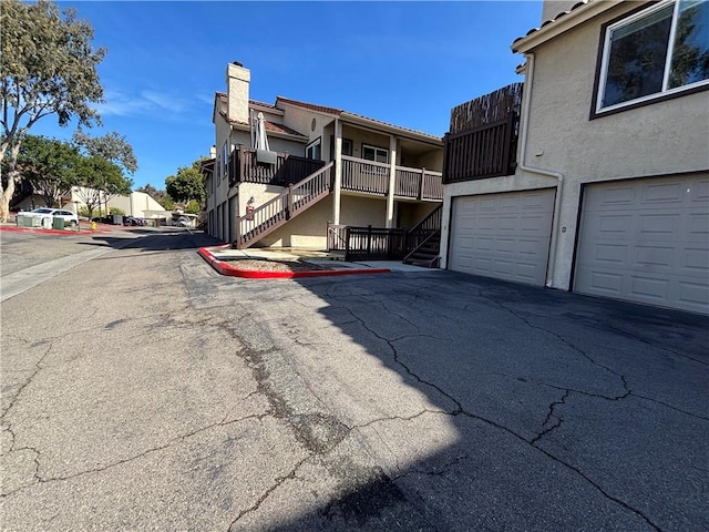 exterior space with stairs, a residential view, and curbs