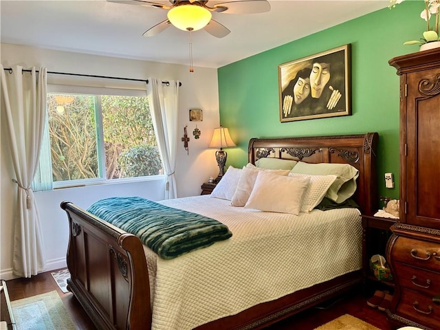 bedroom featuring baseboards, a ceiling fan, and wood finished floors