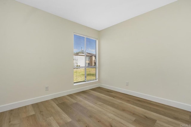 empty room with light hardwood / wood-style flooring