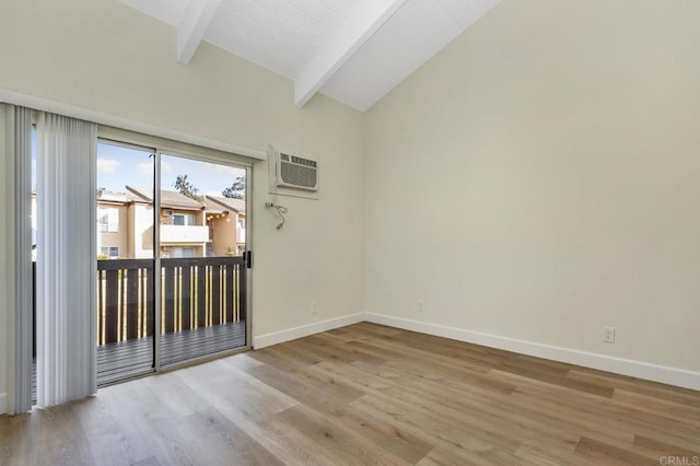 empty room featuring a wall unit AC, vaulted ceiling with beams, light hardwood / wood-style flooring, and wood ceiling