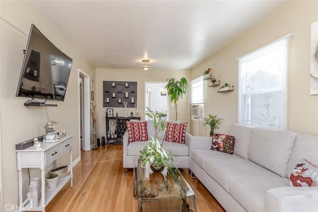 living room with light hardwood / wood-style flooring and cooling unit