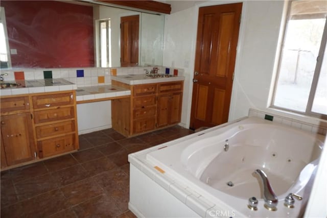 bathroom featuring tile patterned floors, vanity, and a washtub