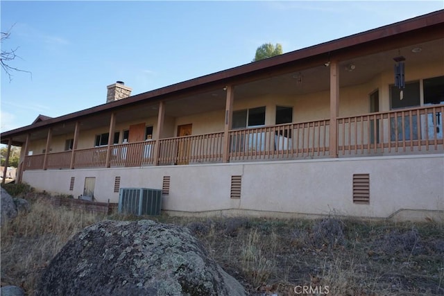 view of side of home featuring central AC