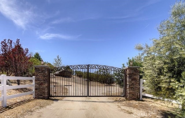 view of gate featuring fence