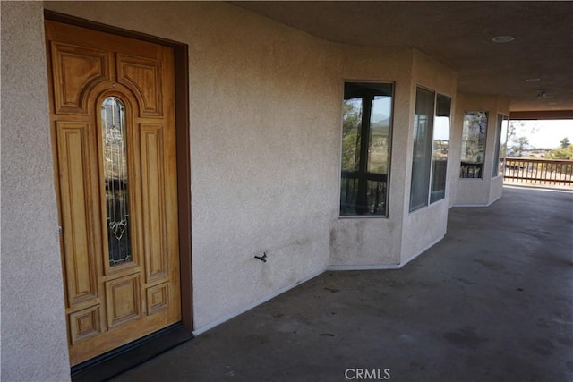 entrance to property with stucco siding