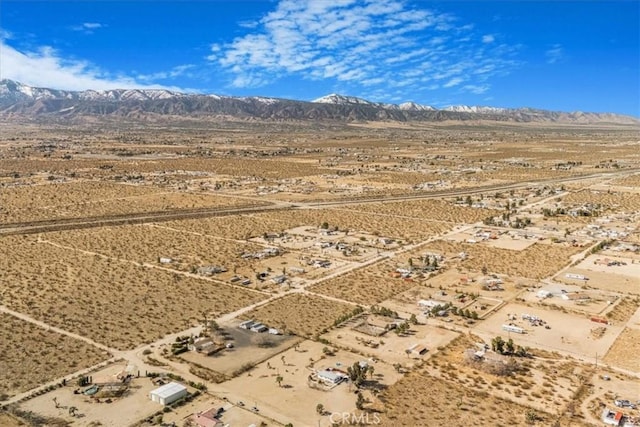 aerial view featuring a mountain view and view of desert