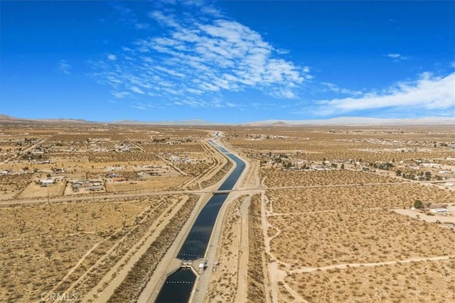 birds eye view of property featuring view of desert and a mountain view