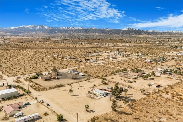 drone / aerial view with view of desert and a mountain view