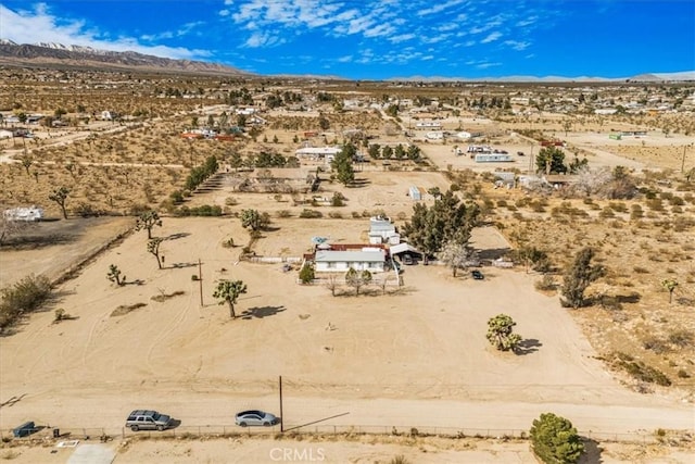 bird's eye view with a desert view and a mountain view