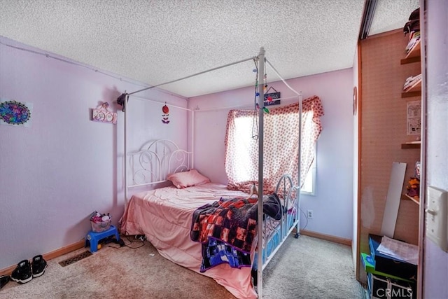 carpeted bedroom with visible vents, a textured ceiling, and baseboards