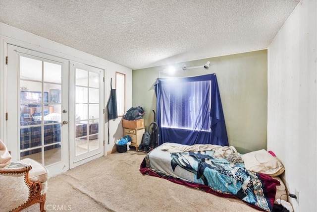 bedroom featuring french doors, multiple windows, carpet, and access to exterior