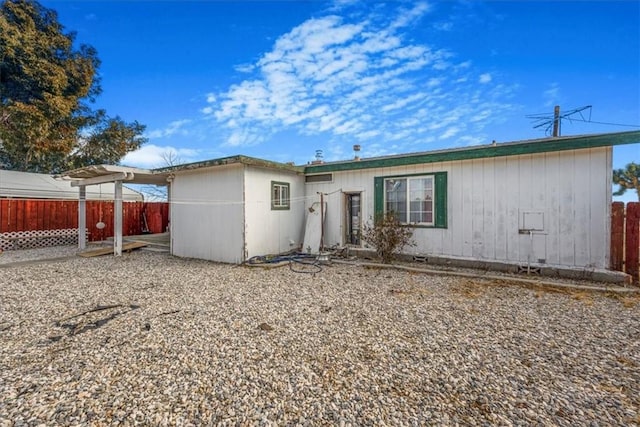 rear view of property with fence