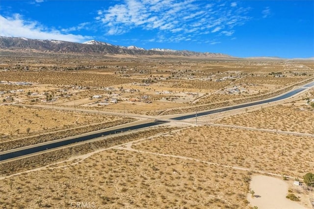 birds eye view of property with view of desert and a mountain view