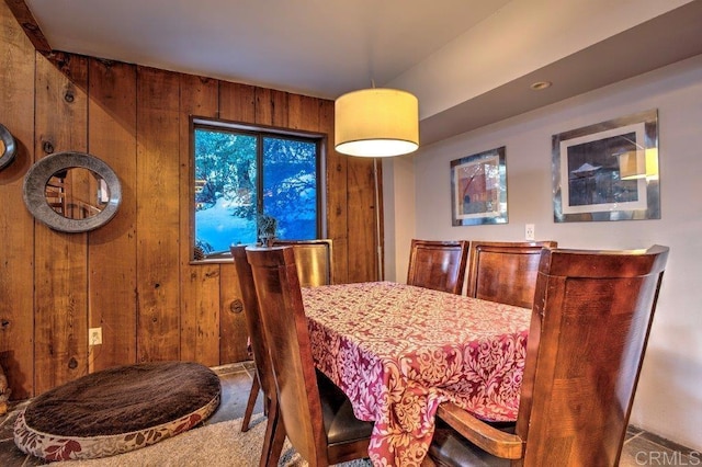 dining room featuring wooden walls