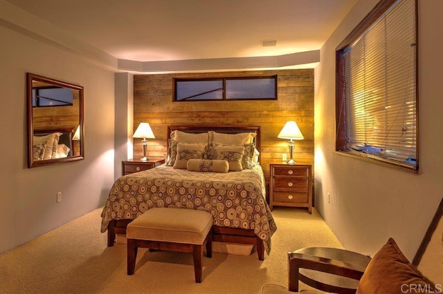 carpeted bedroom with wood walls