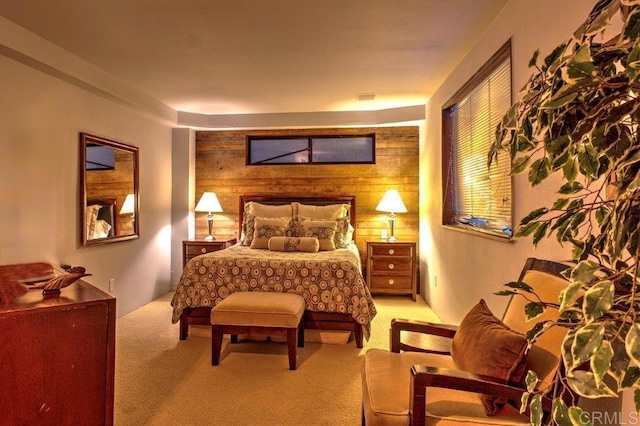 bedroom with wood walls and light carpet