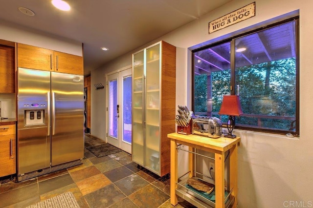 kitchen with stainless steel refrigerator with ice dispenser, butcher block countertops, and french doors