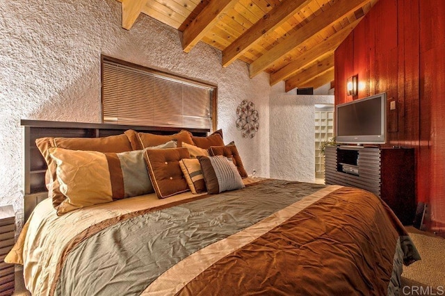 bedroom with vaulted ceiling with beams, wood ceiling, and wood walls