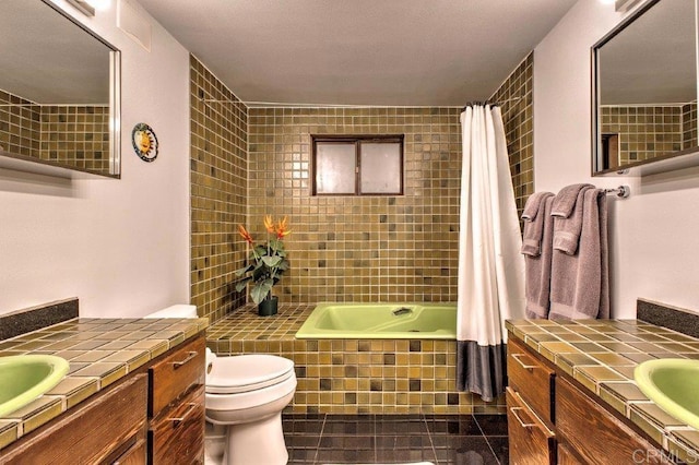 bathroom featuring tile patterned flooring, vanity, and toilet