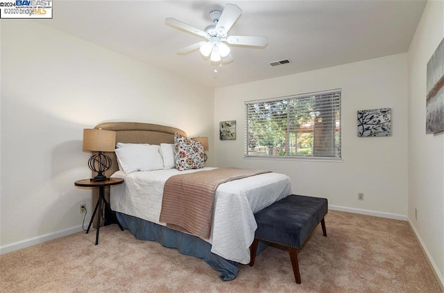 bedroom featuring ceiling fan and light carpet