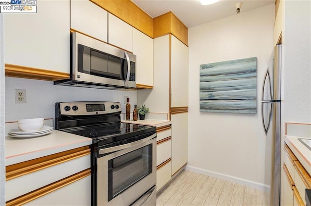 kitchen featuring white cabinets and stainless steel appliances