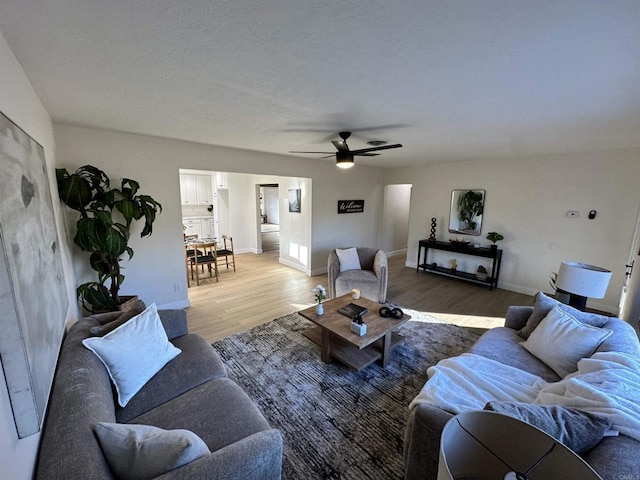 living room with ceiling fan and hardwood / wood-style floors