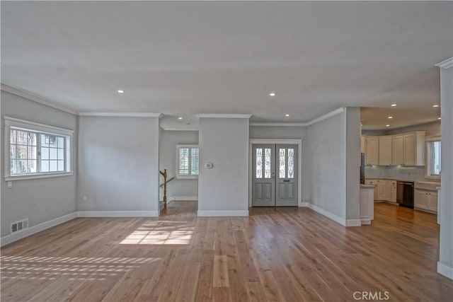 unfurnished living room featuring crown molding and light hardwood / wood-style floors