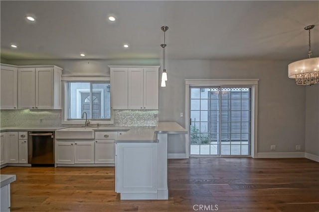 kitchen featuring dishwasher, decorative light fixtures, and a healthy amount of sunlight