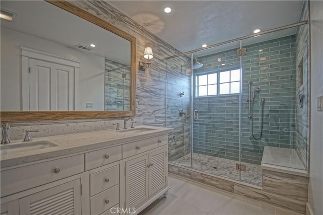 bathroom featuring tile patterned flooring, vanity, and walk in shower