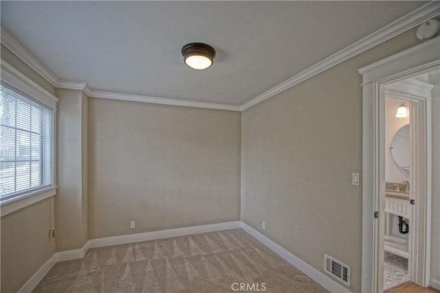 unfurnished room with crown molding and light colored carpet