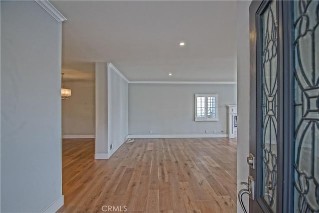 foyer entrance featuring light hardwood / wood-style flooring and ornamental molding