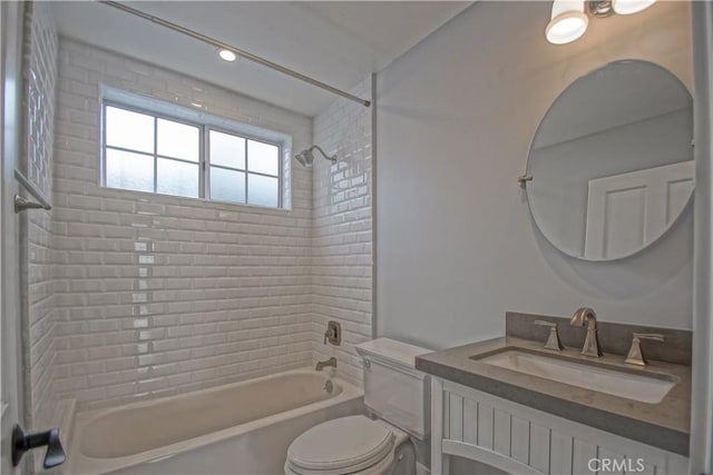 full bathroom featuring vanity, toilet, and tiled shower / bath