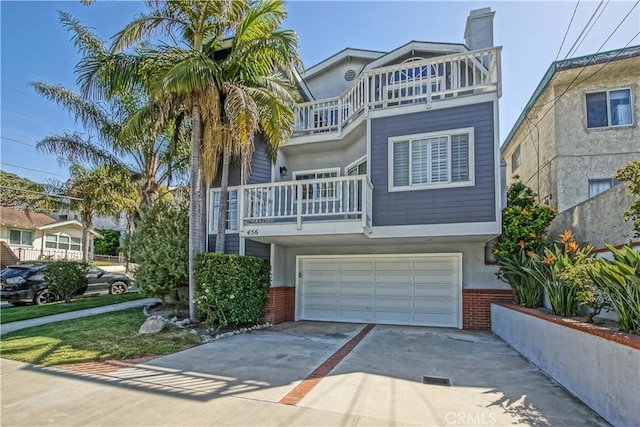 view of front facade featuring a balcony and a garage