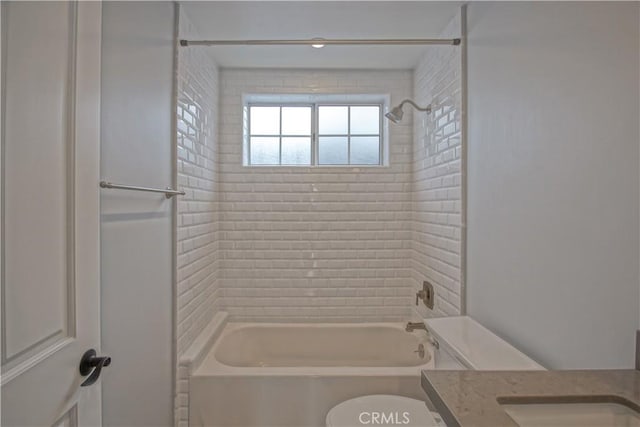 full bathroom with vanity, tiled shower / bath combo, and toilet