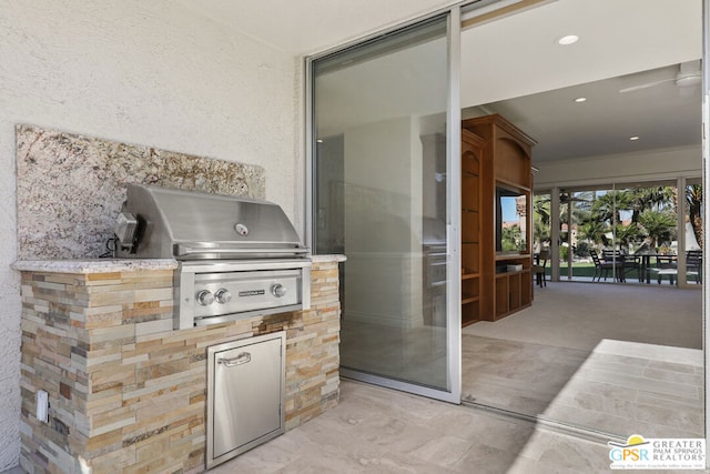 view of patio featuring exterior kitchen and a grill