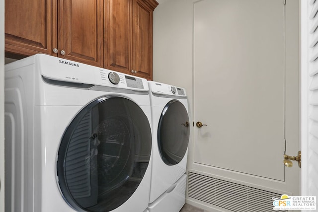 laundry area featuring cabinets and washer and dryer