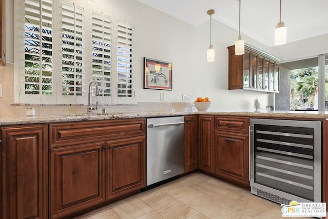 kitchen featuring pendant lighting, wine cooler, sink, light tile patterned floors, and light stone counters