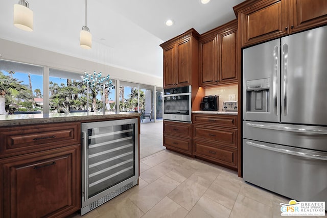 kitchen with decorative light fixtures, wine cooler, a wealth of natural light, and appliances with stainless steel finishes