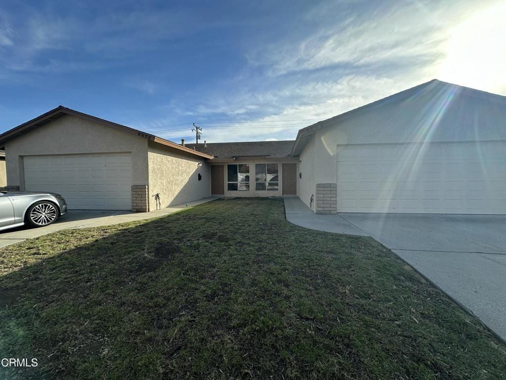 view of front of property with a garage and a front lawn