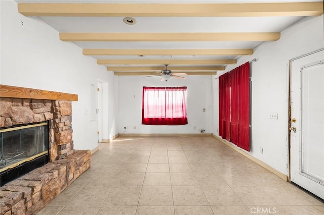 unfurnished living room with beamed ceiling, light tile patterned floors, a stone fireplace, and ceiling fan