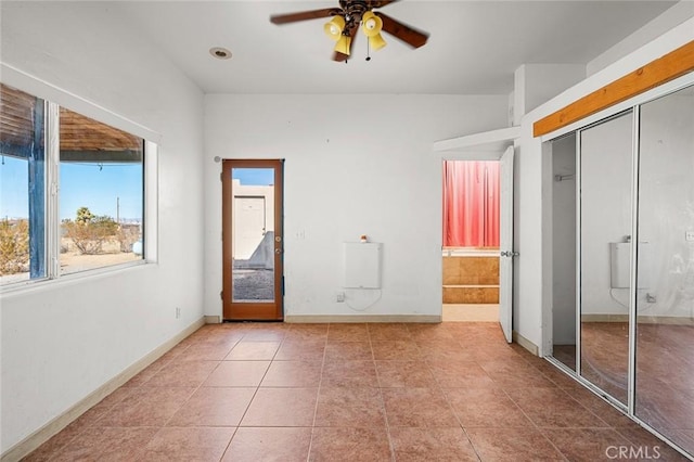 unfurnished bedroom featuring tile patterned flooring, a closet, and ceiling fan