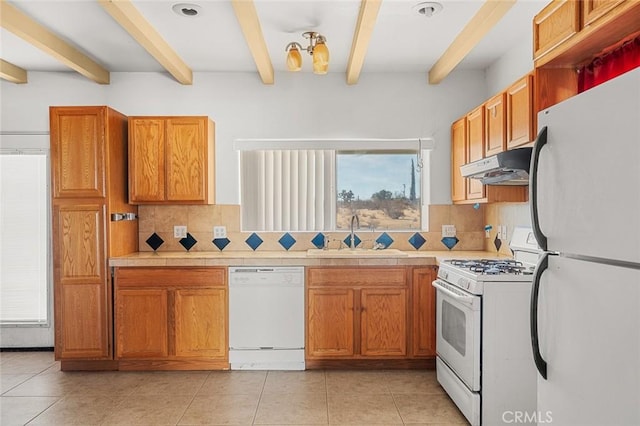 kitchen with backsplash, sink, beamed ceiling, and white appliances