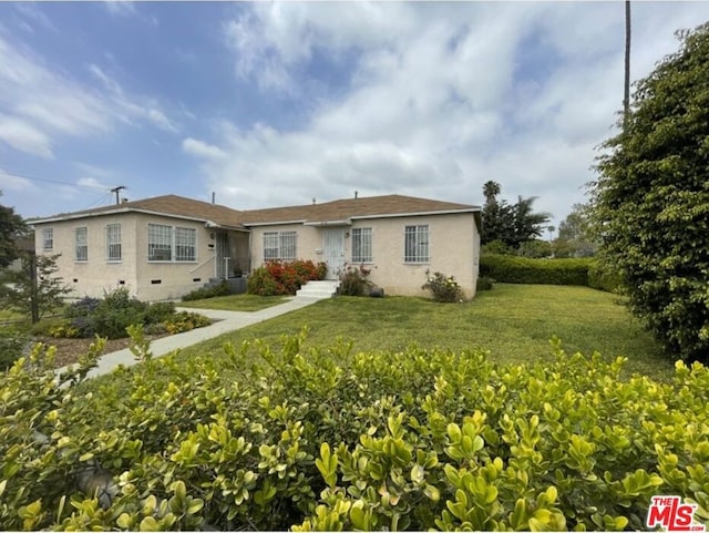 ranch-style home with a front lawn