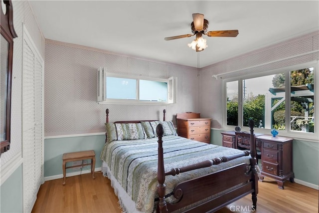 bedroom featuring ceiling fan, ornamental molding, and light hardwood / wood-style floors