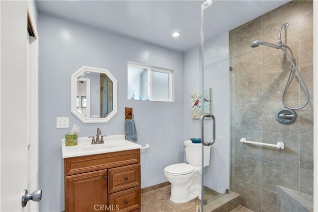 bathroom with a shower with shower door, tile patterned floors, toilet, and vanity