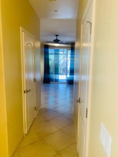 corridor featuring light tile patterned floors