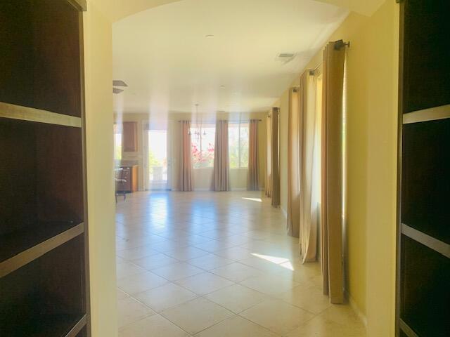 hall featuring light tile patterned flooring